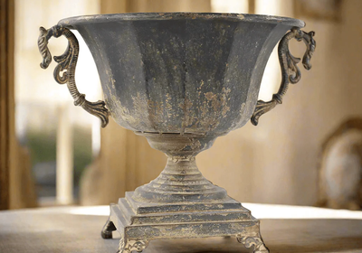 antique_decorative_urn_distressed_metal_historical_charm_timeless_elegance_interior_design_rustic_iron_artifact_1800x1800